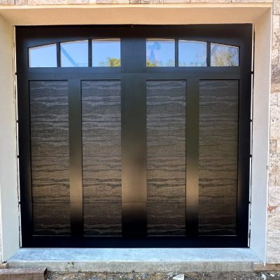 New black carriage-style garage door installed by J&C