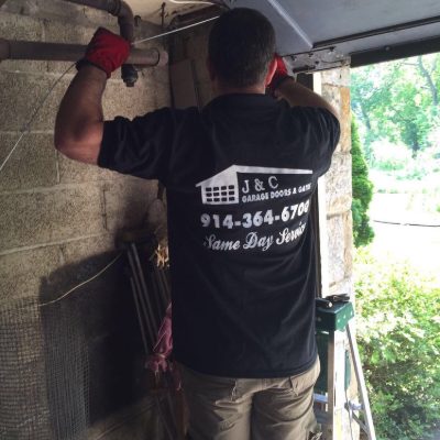 J&C technician fixing a garage door in Westchester